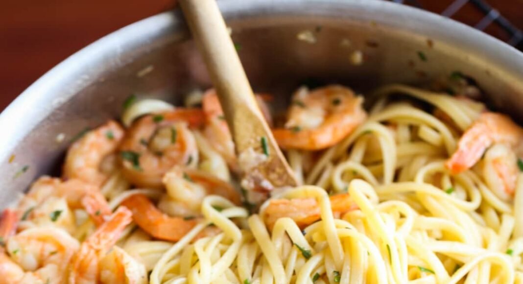 Shrimp scampi in a pan with linguine.