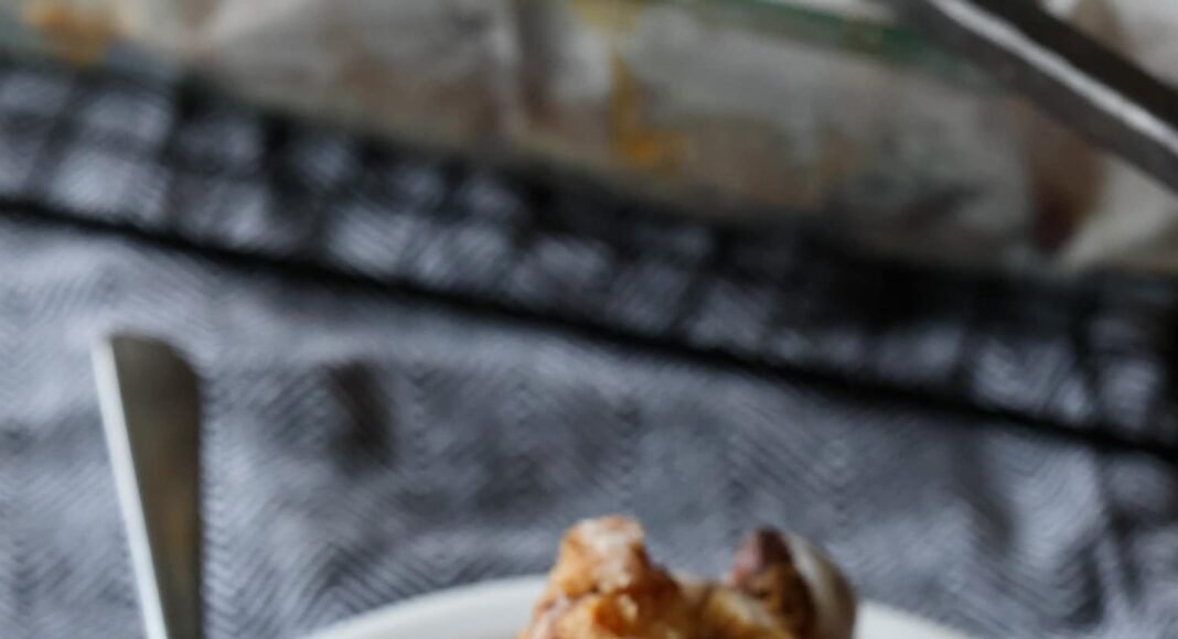 a piece of Cinnamon Roll Dump Cake on a plate with a fork