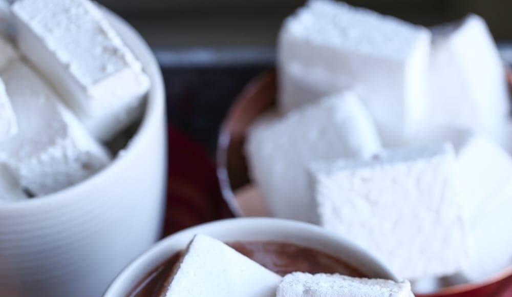 Three Homemade Marshmallows Floating in a Mug of Hot Chocolate