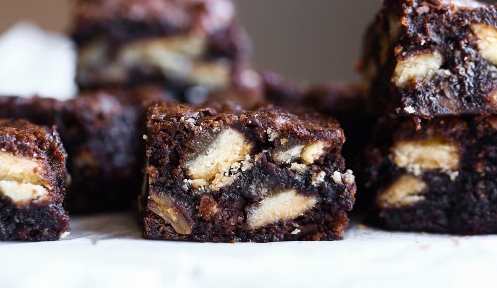 Cut brownies on a platter with pie crust baked inside