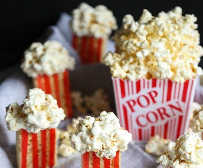 Rice krispie treats movie popcorn snacks around a box of popcorn.