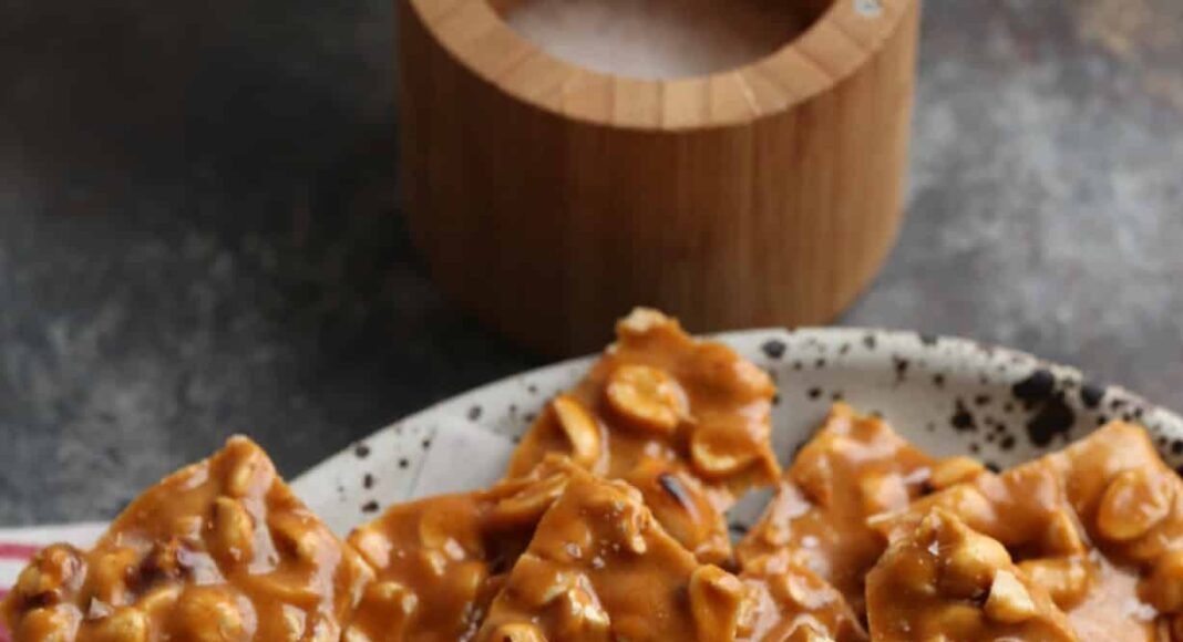 Homemade peanut brittle served on a plate.
