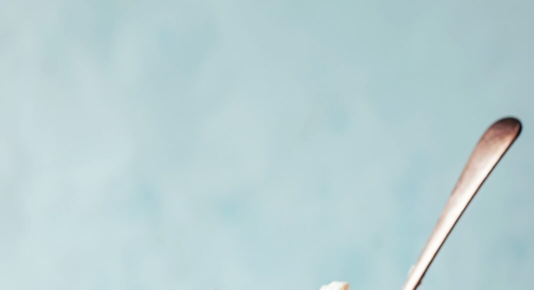 Mug of mocha chia pudding topped with coconut whipped cream and shaved chocolate