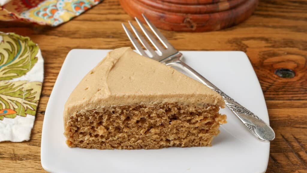 coffee cake with coffee frosting on a plate with a fork