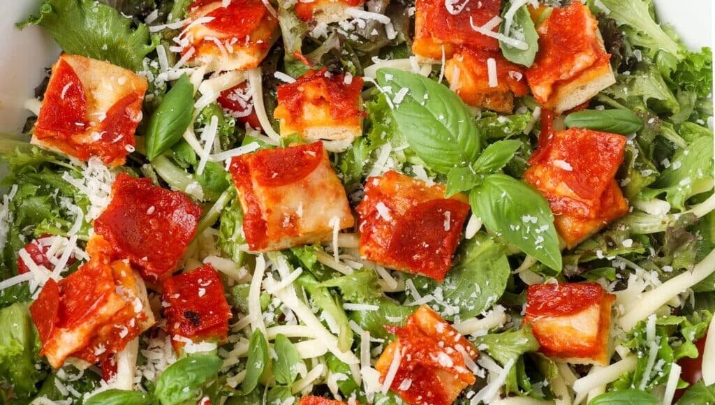 close up horizontal photo of salad with pizza croutons